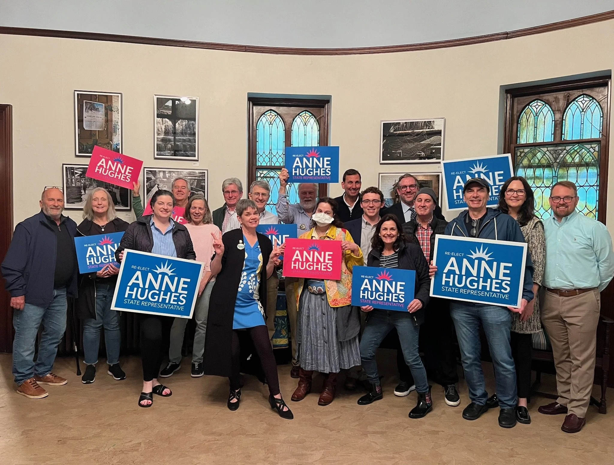 Community supporters holding Anne Hughes signs